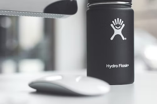 black hydro flask next to a computer mouse